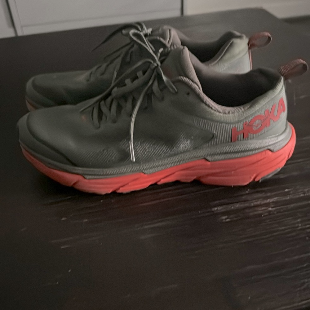 Like new Hoka shoes good for walking and running. Olive green and orange bottom.